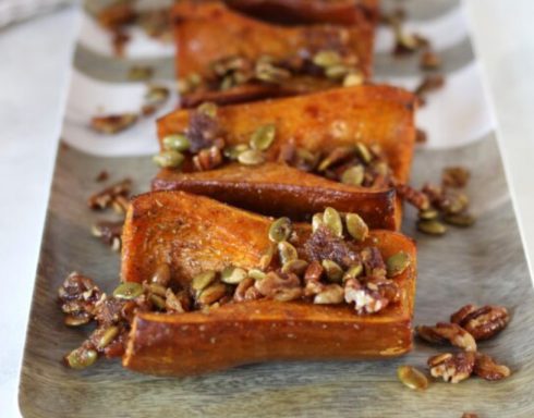 Baked sweet potato slices topped with crunchy pumpkin seeds and nuts.