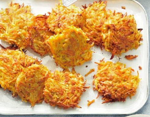 Crispy golden-brown latkes arranged on a white platter.