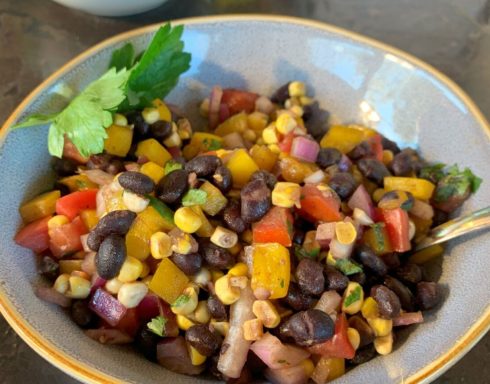 Colorful black bean salad with corn, tomatoes, peppers, and cilantro.